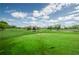 Lush green golf course with pond and flag at 12904 College Hill Dr, Hudson, FL 34667
