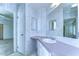 Bathroom with vanity, medicine cabinet and patterned wallpaper at 37608 Lorena Ave, Zephyrhills, FL 33541