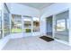 Enclosed porch with tile floor, access to yard, and sliding glass door at 37608 Lorena Ave, Zephyrhills, FL 33541