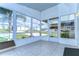 Bright screened porch with tile floors and view of the community at 37608 Lorena Ave, Zephyrhills, FL 33541