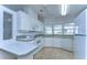 Efficient kitchen with white cabinets, built-in appliances, and tile floors at 37608 Lorena Ave, Zephyrhills, FL 33541