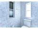 Small bathroom with toilet and two windows at 37608 Lorena Ave, Zephyrhills, FL 33541