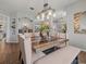 Dining area with a rustic wood table and light beige chairs, view into kitchen at 14173 Pullman Dr, Spring Hill, FL 34609