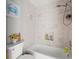 Clean bathroom with a tub and shower, updated tile, and stylish decor at 14173 Pullman Dr, Spring Hill, FL 34609