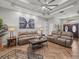 Spacious living room featuring two brown leather sofas, a coffee table, and wood-look flooring at 14173 Pullman Dr, Spring Hill, FL 34609