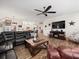 Open concept living room with a sectional sofa and large TV, kitchen view at 14173 Pullman Dr, Spring Hill, FL 34609