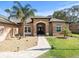Brick home with covered entryway and manicured landscaping at 14173 Pullman Dr, Spring Hill, FL 34609