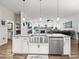 Kitchen island with farmhouse sink and stainless steel appliances at 14173 Pullman Dr, Spring Hill, FL 34609