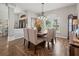 Formal dining room with a wood table and six beige chairs, hardwood floors at 14173 Pullman Dr, Spring Hill, FL 34609