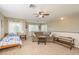 Spacious bonus room with couch, twin bed, and ample natural light at 12923 Carlington Ln, Riverview, FL 33579