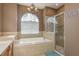 Bathroom with soaking tub, shower, and updated fixtures at 12923 Carlington Ln, Riverview, FL 33579
