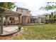 Home's backyard with pergola, patio, and pool area at 12923 Carlington Ln, Riverview, FL 33579