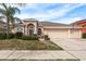 One-story house with a three-car garage and manicured lawn at 12923 Carlington Ln, Riverview, FL 33579