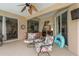 Covered patio with comfy seating and views of the backyard at 12923 Carlington Ln, Riverview, FL 33579