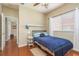 Well-lit bedroom with a double bed, nightstand, and access to hallway at 12923 Carlington Ln, Riverview, FL 33579