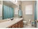 Clean bathroom with light teal accents and a pedestal sink at 12923 Carlington Ln, Riverview, FL 33579