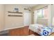Bright bedroom with wood floors, twin bed, and built-in shelving at 12923 Carlington Ln, Riverview, FL 33579