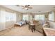Bright bonus room with a couch, twin bed, and ceiling fan at 12923 Carlington Ln, Riverview, FL 33579