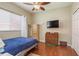 Spacious bedroom with hardwood floors, a double bed, and ample storage at 12923 Carlington Ln, Riverview, FL 33579
