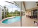 Inviting kidney-shaped pool with screened enclosure and patio at 12923 Carlington Ln, Riverview, FL 33579