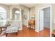 Living room with hardwood floors, a comfy chair, and built-in shelving at 12923 Carlington Ln, Riverview, FL 33579