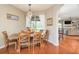 Bright dining room with a wooden table and chairs, looking into the Gathering room at 12923 Carlington Ln, Riverview, FL 33579