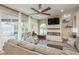 Living room with fireplace, large sectional sofa, and pool access at 12923 Carlington Ln, Riverview, FL 33579