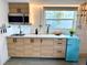 Close-up of modern kitchen area with sleek cabinets, stainless steel appliances, and quirky decor at 147 42Nd Ne Ave, St Petersburg, FL 33703