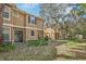 Townhouse with backyard, landscaping, and mature trees at 16610 Kingletside Ct, Lithia, FL 33547