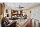 Open concept living room with beamed ceilings, hardwood floors, and a seamless flow to the kitchen at 3341 Gulf Blvd, Belleair Beach, FL 33786