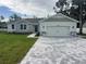 Newly constructed home with stone accents and a paved driveway at 37570 Teri Ct, Dade City, FL 33525