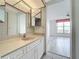 Bathroom featuring a vanity, mirror, and an open view to a bedroom at 4410 Fairways Blvd Blvd # 607, Bradenton, FL 34209