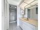 Bathroom featuring white cabinets, a mirror, and a walk-in shower at 4410 Fairways Blvd Blvd # 607, Bradenton, FL 34209