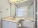 Bathroom featuring white cabinets, a mirror, and a toilet at 4410 Fairways Blvd Blvd # 607, Bradenton, FL 34209