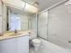 Bathroom featuring white cabinets, a mirror, and a shower tub at 4410 Fairways Blvd Blvd # 607, Bradenton, FL 34209