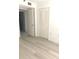 Bright bedroom featuring wood-look flooring, a double closet, and an ensuite bathroom entry at 4410 Fairways Blvd Blvd # 607, Bradenton, FL 34209