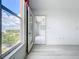 Bright bedroom with light wood floors, a large window, and access to the lanai at 4410 Fairways Blvd Blvd # 607, Bradenton, FL 34209