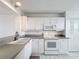 Well-lit kitchen featuring white appliances and ample cabinet space at 4410 Fairways Blvd Blvd # 607, Bradenton, FL 34209
