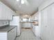 White kitchen featuring ample storage space and a pass-through to the dining area at 4410 Fairways Blvd Blvd # 607, Bradenton, FL 34209