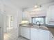 Bright kitchen featuring white cabinets and a passthrough to the dining area at 4410 Fairways Blvd Blvd # 607, Bradenton, FL 34209