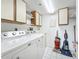 Laundry room featuring a washer, dryer, shelving, and cabinets at 4410 Fairways Blvd Blvd # 607, Bradenton, FL 34209