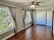 Bright bedroom with wood-look floors and large windows at 2360 World Parkway Blvd # 54, Clearwater, FL 33763