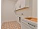 Laundry room with white cabinets and patterned tile floor at 2919 W Elrod Ave, Tampa, FL 33611