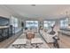 Spacious living room with hardwood floors, comfortable seating, and a view to backyard at 2919 W Elrod Ave, Tampa, FL 33611