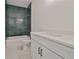 Modern bathroom with green tile and white vanity at 2919 W Elrod Ave, Tampa, FL 33611