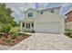 Two-story house with light-colored siding and a driveway at 2919 W Elrod Ave, Tampa, FL 33611