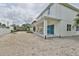 Two-story house with covered patio and sandy backyard at 2919 W Elrod Ave, Tampa, FL 33611