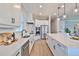 Modern kitchen with white cabinets, stainless steel appliances, and quartz countertops at 2919 W Elrod Ave, Tampa, FL 33611