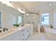 Modern bathroom with double vanity, large shower, and soaking tub at 2919 W Elrod Ave, Tampa, FL 33611