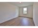 Simple bedroom with hardwood floors and a window at 2919 W Elrod Ave, Tampa, FL 33611